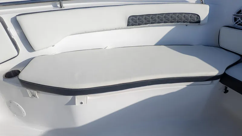 Slide: The Image of 2025 Tidewater 220cc boat interior seating with cup holder and cushioned backrest. - 17