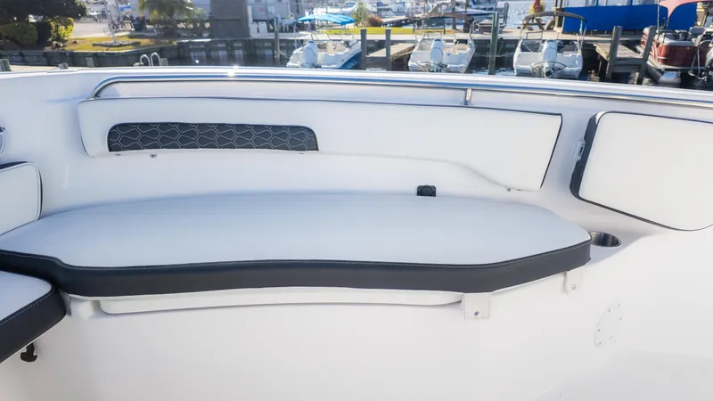 Slide: The Image of 2025 Tidewater 220cc boat interior with white cushioned seating and sleek design. - 20