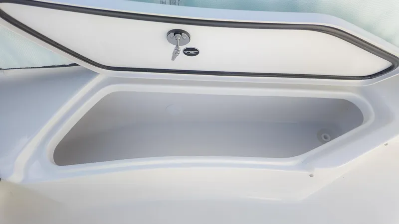 Slide: The Image of Open storage compartment on 2025 Tidewater 220cc boat, featuring secure lock and key. - 21