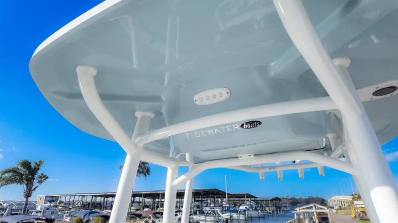 Slide: The Image of 2025 Tidewater 220cc boat canopy with marina background and clear blue sky. - 22