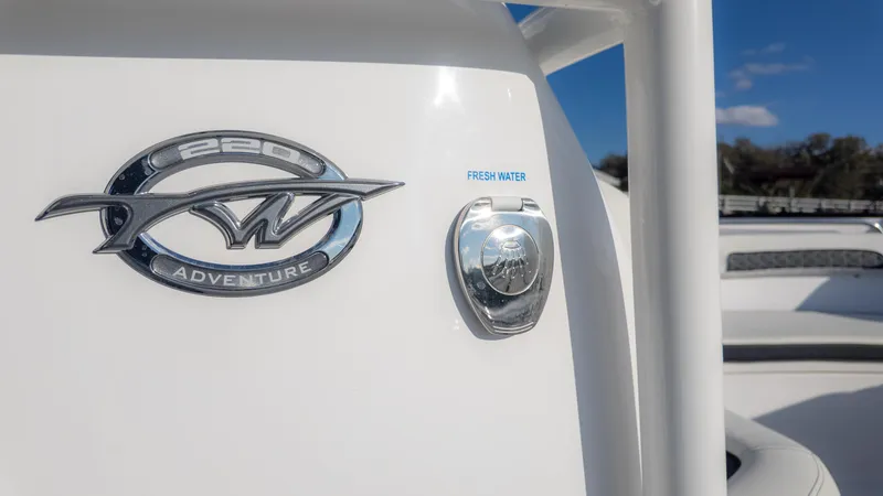 Slide: The Image of 2025 Tidewater 220cc Adventure boat emblem and fresh water access. - 23