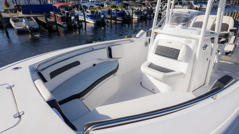 Slide: The Image of 2025 Tidewater 220cc boat interior with seating, docked at marina. - 3