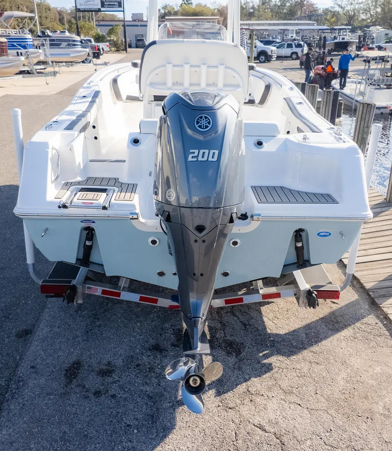 Slide: The Image of 2025 Tidewater 220cc boat with Yamaha 200 outboard motor, docked at marina. - 6