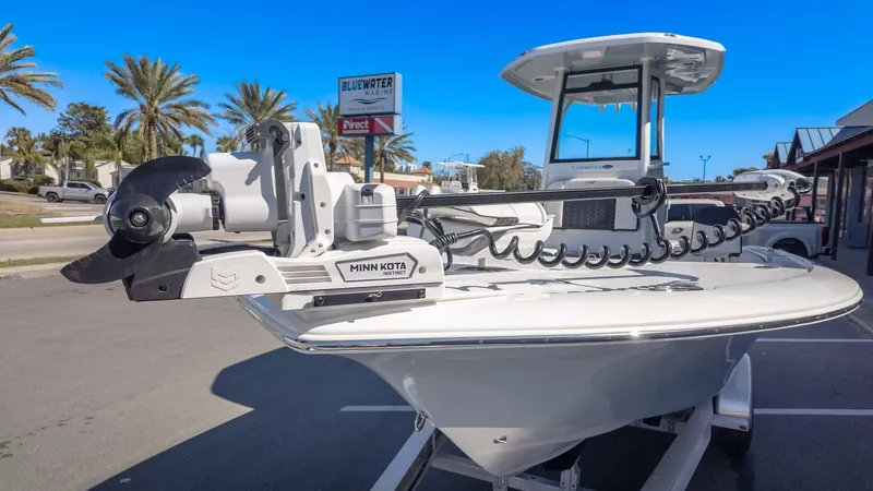 Slide: The Image of 2025 Tidewater 2500 Carolina Bay boat with Minn Kota motor in marina setting. - 3