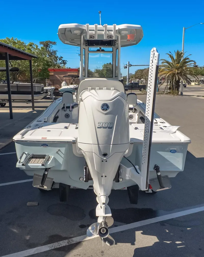 Slide: The Image of 2025 Tidewater 2500 Carolina Bay boat with powerful 300 horsepower engine, parked outdoors. - 5