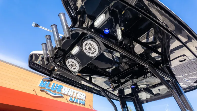 Slide: The Image of 2025 Tidewater 2500 Carolina Bay boat with rod holders and speakers at Bluewater Marine. - 11