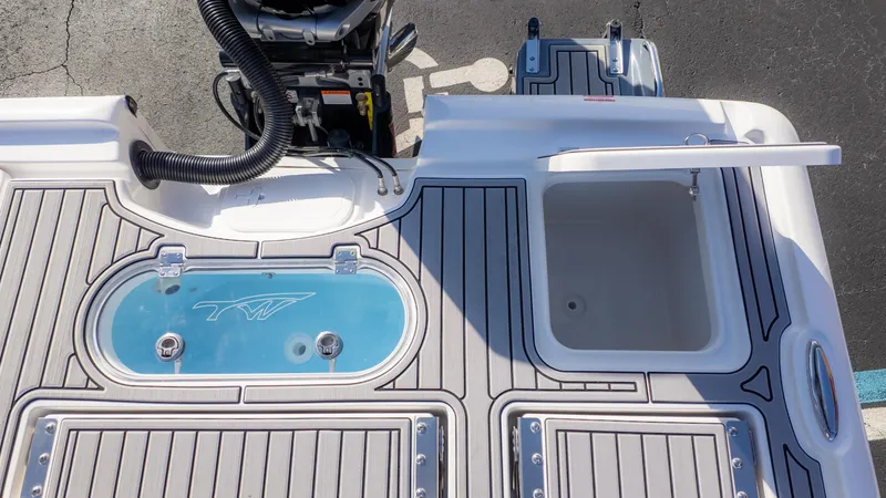 Slide: The Image of 2025 Tidewater 2500 Carolina Bay boat deck with livewell and storage compartments. - 13