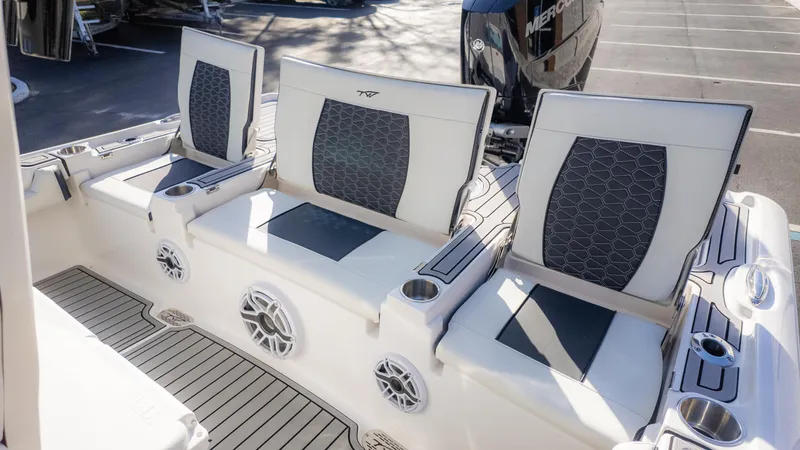 Slide: The Image of 2025 Tidewater 2500 Carolina Bay boat seating with cup holders and speakers. - 14