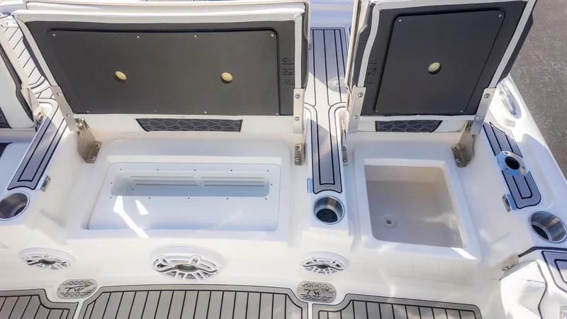 Slide: The Image of 2025 Tidewater 2500 Carolina Bay boat interior with storage compartments and seating. - 15