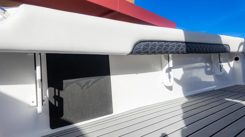 Slide: The Image of 2025 Tidewater 2500 Carolina Bay boat interior with cushioned seating and sleek design. - 16