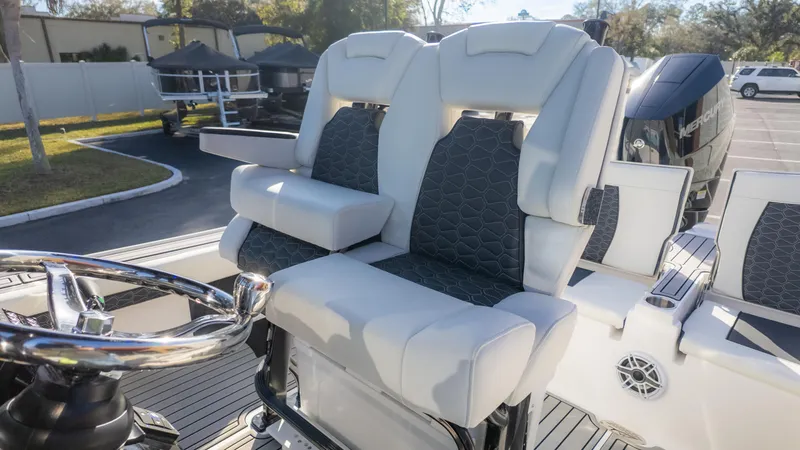 Slide: The Image of 2025 Tidewater 2500 Carolina Bay boat interior with dual seats and steering wheel. - 18