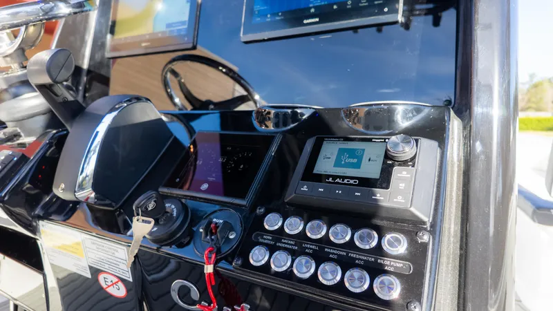 Slide: The Image of Control panel of 2025 Tidewater 2500 Carolina Bay boat with JL Audio system. - 21
