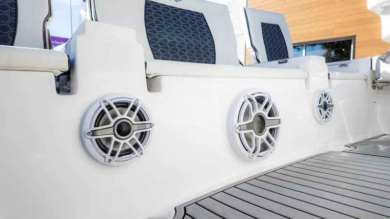Slide: The Image of 2025 Tidewater 2500 Carolina Bay boat interior with JL Audio speakers and stylish seating. - 22