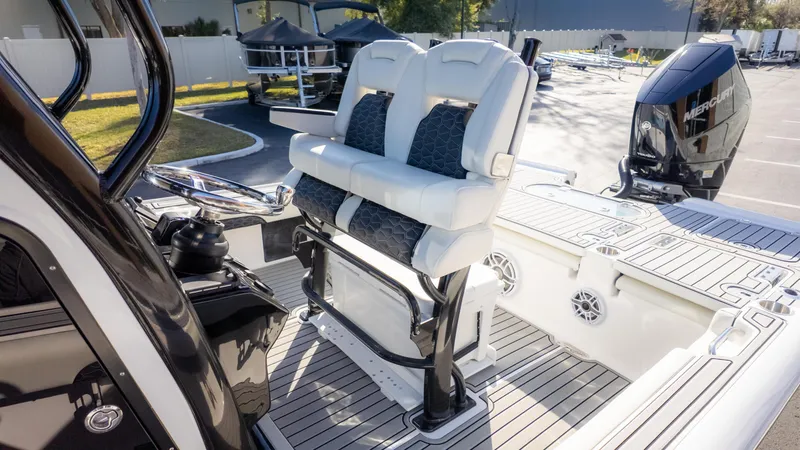 Slide: The Image of 2025 Tidewater 2500 Carolina Bay boat interior with dual seats and Mercury engine. - 4