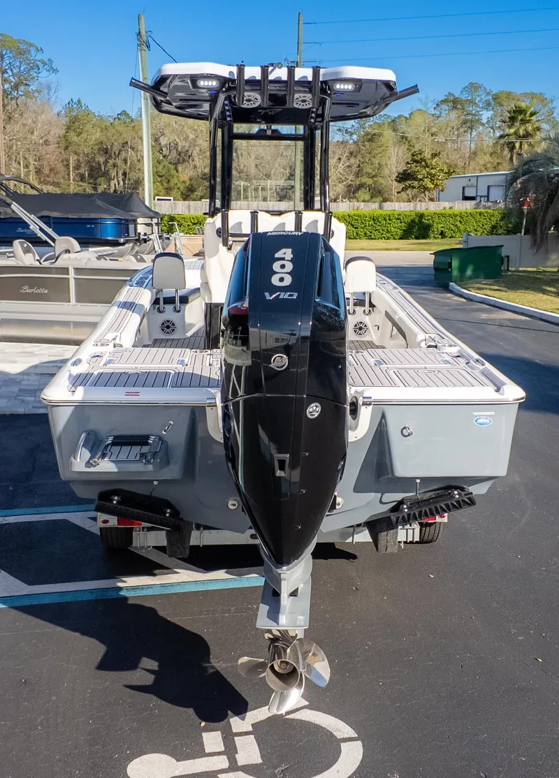 Slide: The Image of 2025 Tidewater 2500 Carolina Bay boat with powerful 400 V10 engine, parked outdoors. - 6