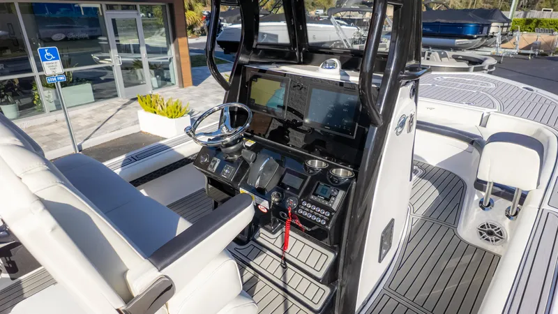 Slide: The Image of 2025 Tidewater 2500 Carolina Bay boat interior with modern dashboard and seating. - 8