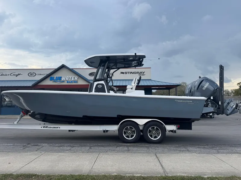 Slide: The Image of 2025 Tidewater 2700 Carolina Bay boat on trailer at Bluewater Marine dealership. - 1