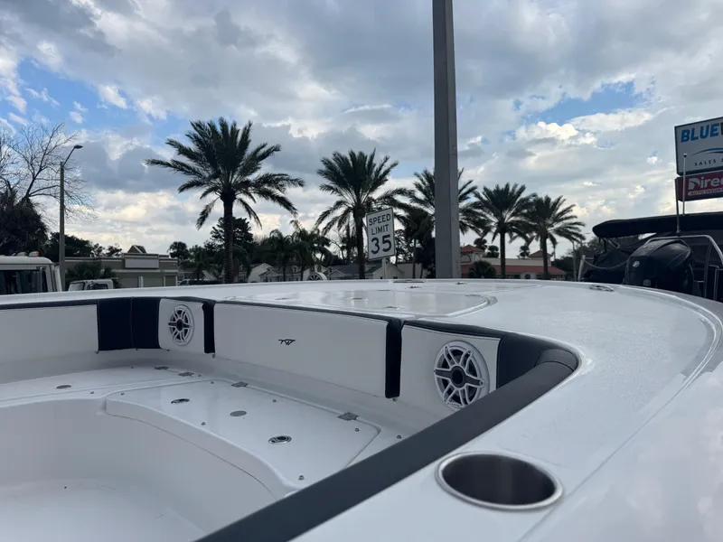 Slide: The Image of 2025 Tidewater 2700 Carolina Bay boat with palm trees and cloudy sky background. - 13