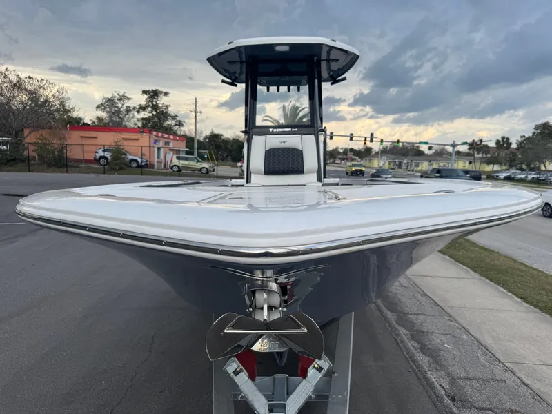 Slide: The Image of 2025 Tidewater 2700 Carolina Bay boat on trailer, street background, cloudy sky. - 14