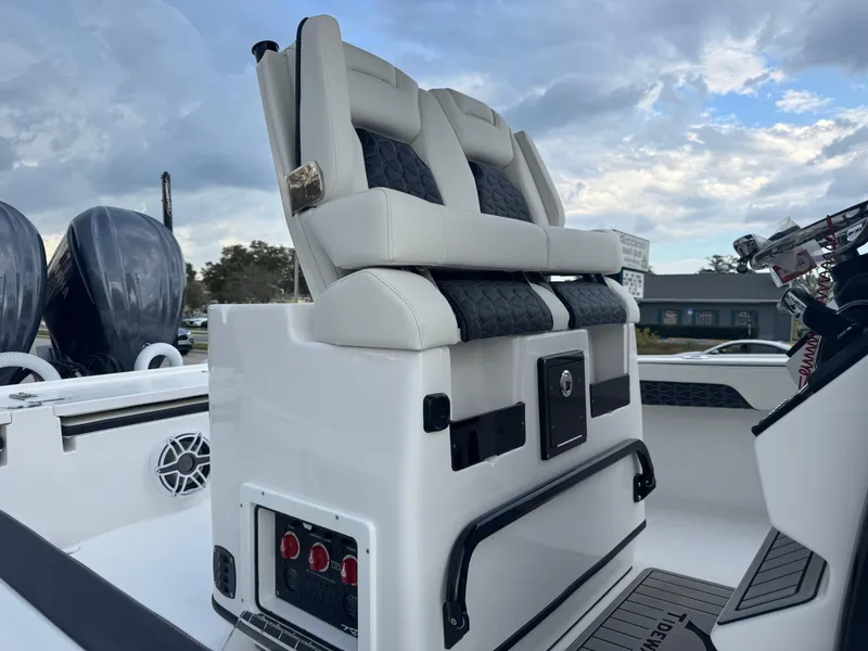 Slide: The Image of 2025 Tidewater 2700 Carolina Bay boat interior with dual seats and control panel. - 16