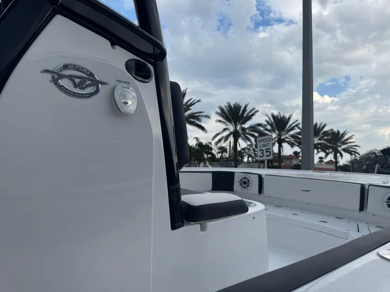 Slide: The Image of 2025 Tidewater 2700 Carolina Bay boat with palm trees and speed limit sign in background. - 17