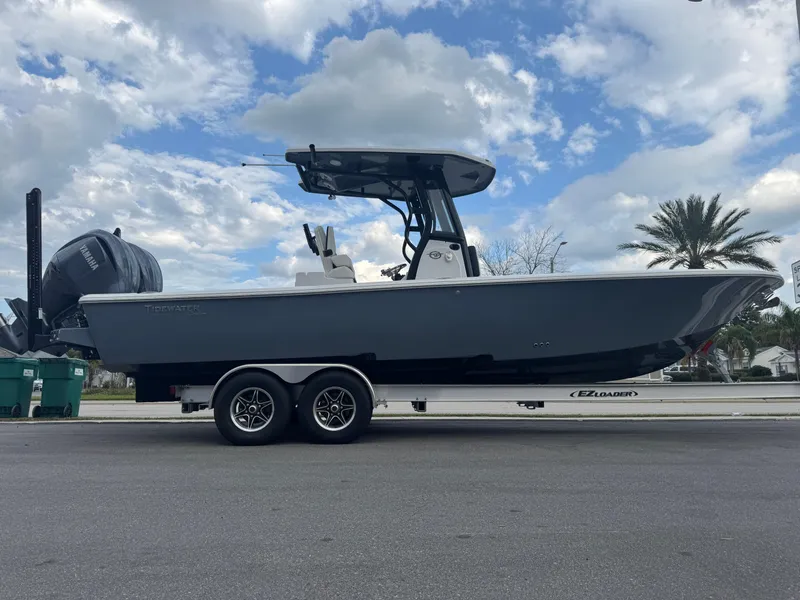 Slide: The Image of 2025 Tidewater 2700 Carolina Bay boat on trailer under cloudy sky. - 2