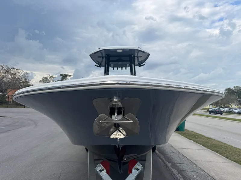 Slide: The Image of 2025 Tidewater 2700 Carolina Bay boat on trailer, viewed from the front under cloudy sky. - 5
