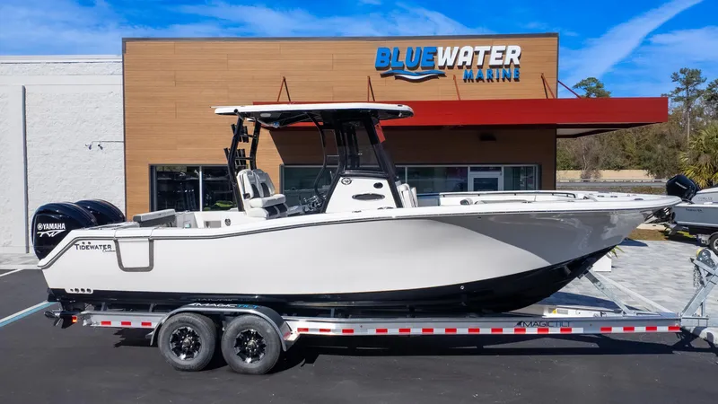 Slide: The Image of 2025 Tidewater 282CC boat on trailer at Bluewater Marine dealership. - 1