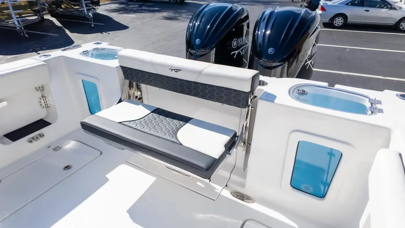 Slide: The Image of 2025 Tidewater 282CC boat interior with seating and dual Yamaha outboard engines. - 12