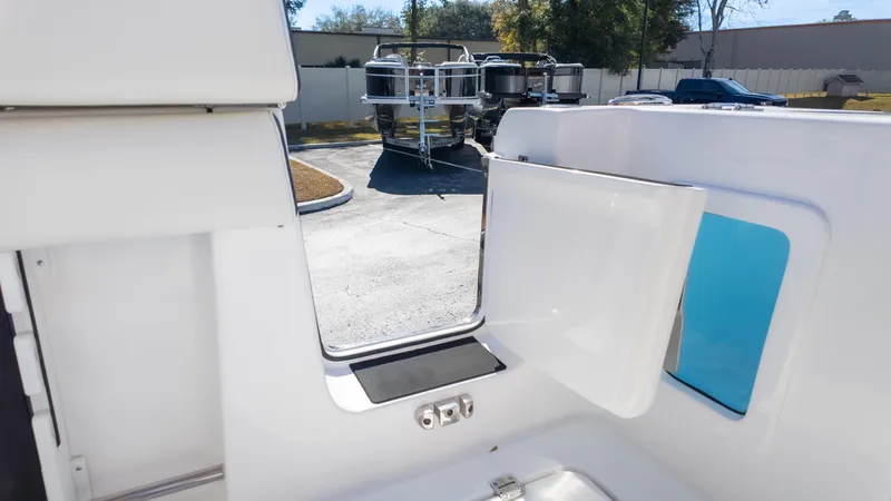 Slide: The Image of 2025 Tidewater 282CC boat interior with open door, showcasing sleek design and outdoor view. - 14