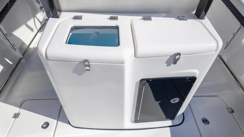 Slide: The Image of 2025 Tidewater 282CC boat storage compartment with secure latches and sleek design. - 15