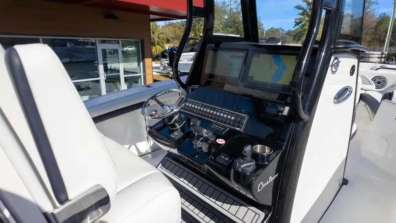 Slide: The Image of 2025 Tidewater 282CC boat cockpit with modern navigation system and sleek design. - 19
