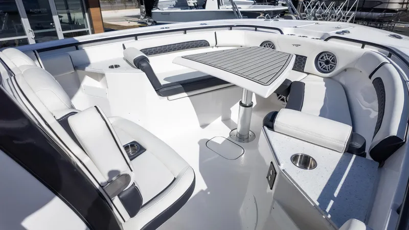 Slide: The Image of 2025 Tidewater 282CC boat interior with sleek seating and modern table design. - 23