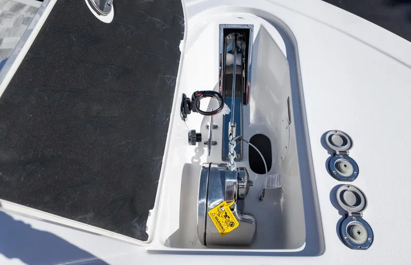 Slide: The Image of 2025 Tidewater 282CC boat anchor compartment with winch and controls. - 26
