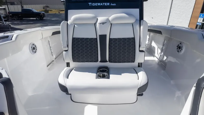 Slide: The Image of 2025 Tidewater 282CC boat interior with cushioned seating and cup holders. - 28