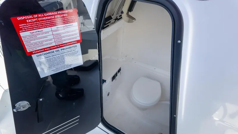 Slide: The Image of 2025 Tidewater 282CC boat interior with a compact marine toilet. - 29