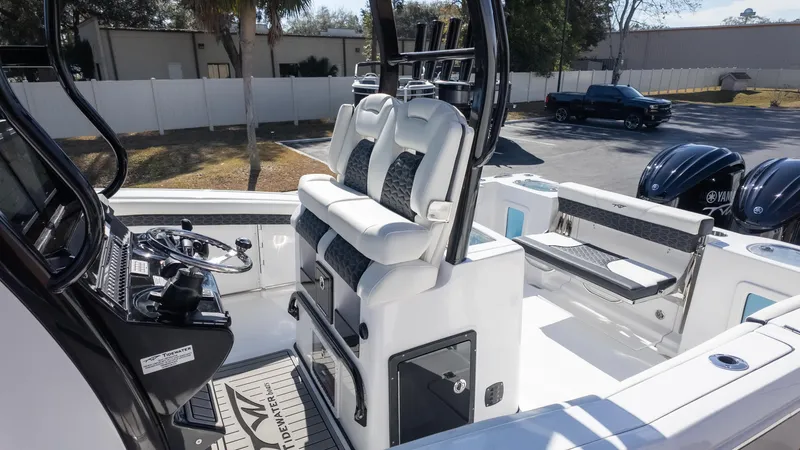 Slide: The Image of 2025 Tidewater 282CC boat interior with dual seats and steering console. - 6