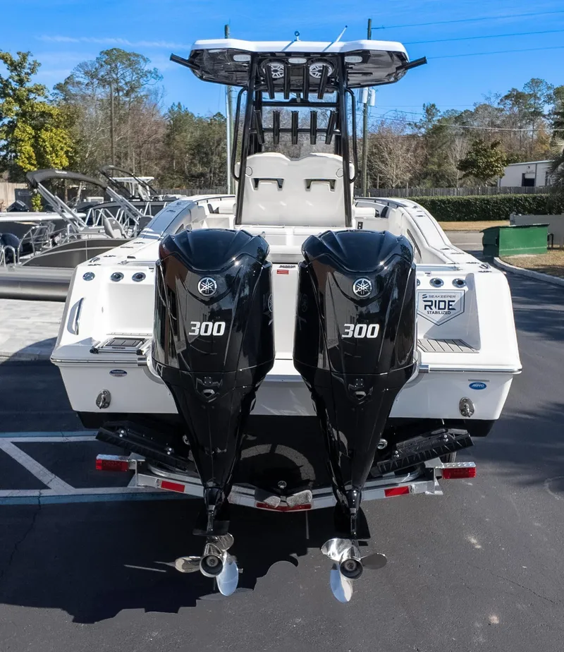 Slide: The Image of 2025 Tidewater 282CC boat with dual 300 horsepower engines, parked outdoors. - 7