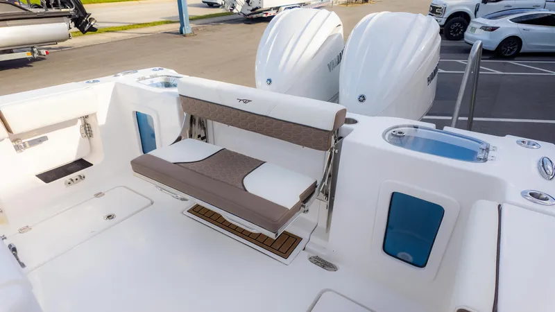 Slide: The Image of 2025 Tidewater 282CC boat with dual engines and foldable seating on deck. - 14