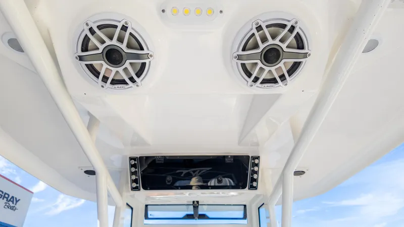 Slide: The Image of 2025 Tidewater 282CC boat speakers and control panel under canopy. - 19