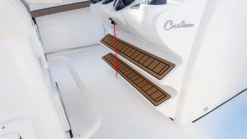 Slide: The Image of 2025 Tidewater 282CC boat interior with custom step design and safety features. - 20