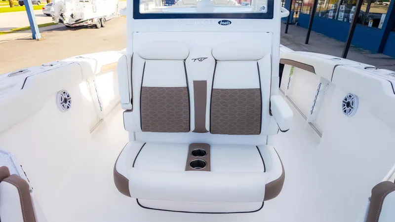 Slide: The Image of 2025 Tidewater 282CC boat interior with cushioned seating and cup holders. - 21