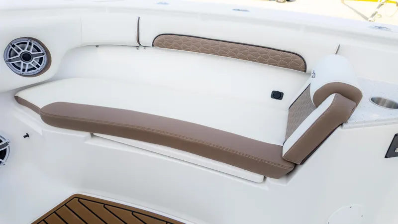 Slide: The Image of 2025 Tidewater 282CC boat interior with cushioned seating and speaker. - 22
