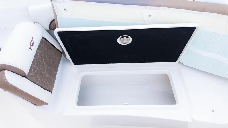 Slide: The Image of Storage compartment on 2025 Tidewater 282CC boat with cushioned seating. - 23