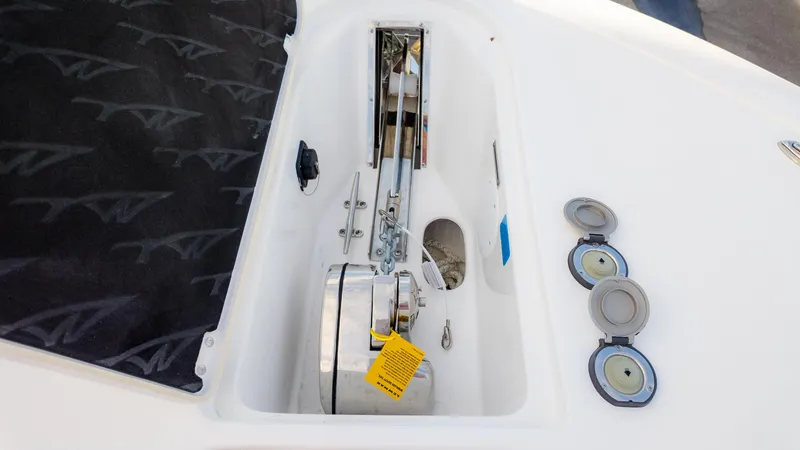 Slide: The Image of 2025 Tidewater 282CC boat anchor compartment with winch and storage. - 24