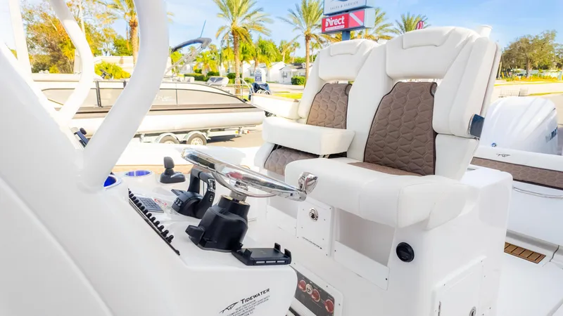 Slide: The Image of 2025 Tidewater 282CC boat interior with plush seating and modern steering console. - 27