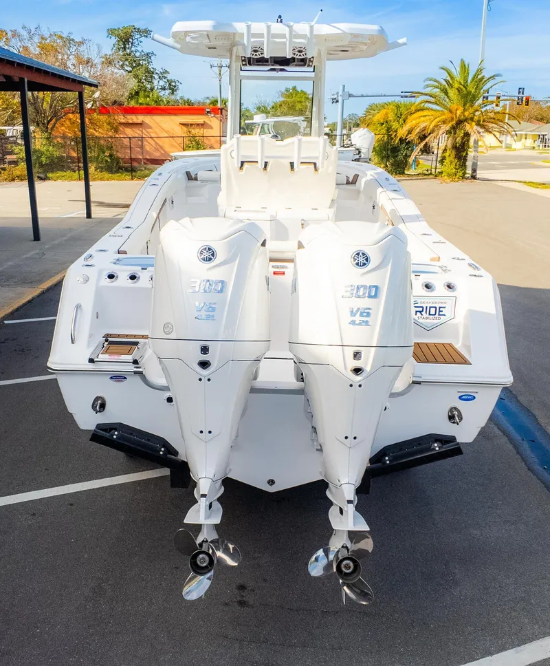Slide: The Image of 2025 Tidewater 282CC boat with dual Yamaha 300 V6 engines, parked outdoors. - 7