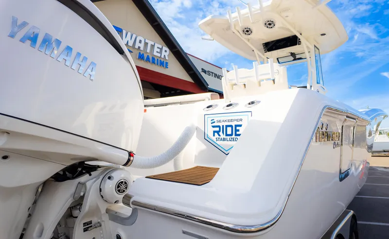 Slide: The Image of 2025 Tidewater 282CC boat with Yamaha engine and Seakeeper Ride stabilization at a marine dealership. - 8
