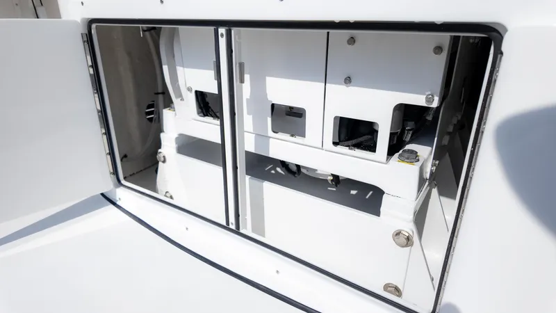Slide: The Image of 2025 Tidewater 320cc boat storage compartment with open hatch, showcasing interior details. - 15