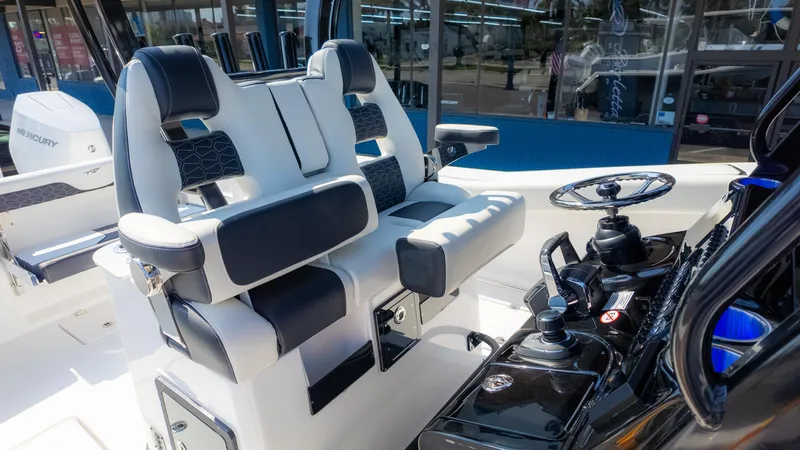 Slide: The Image of 2025 Tidewater 320cc boat interior with modern helm and seating. - 18